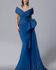 MNM Couture 2692 is the definition of elegance. This beautiful pleated off the shoulder gown with side train hugs curves and compliments all figures.