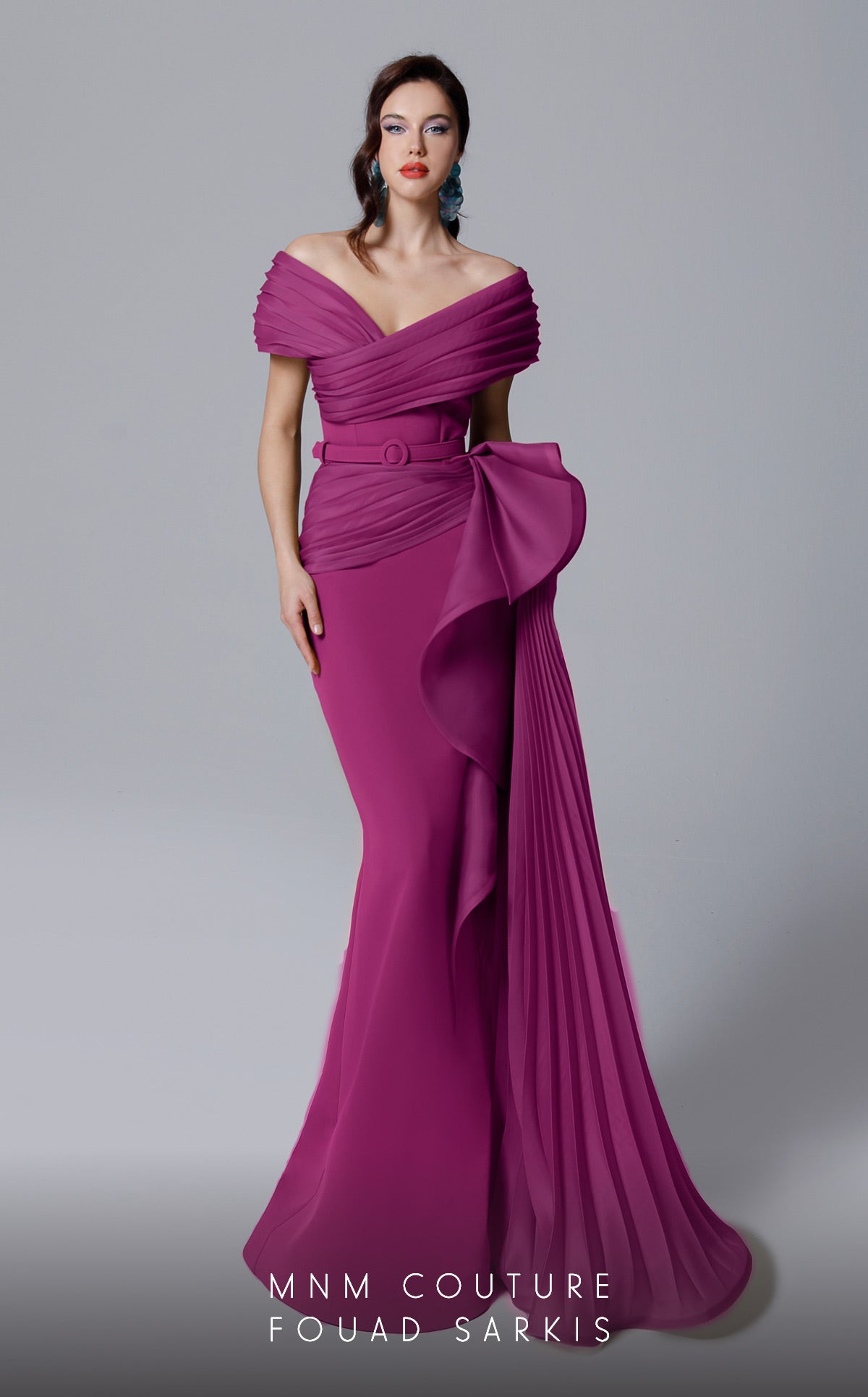 MNM Couture 2692 is the definition of elegance. This beautiful pleated off the shoulder gown with side train hugs curves and compliments all figures.