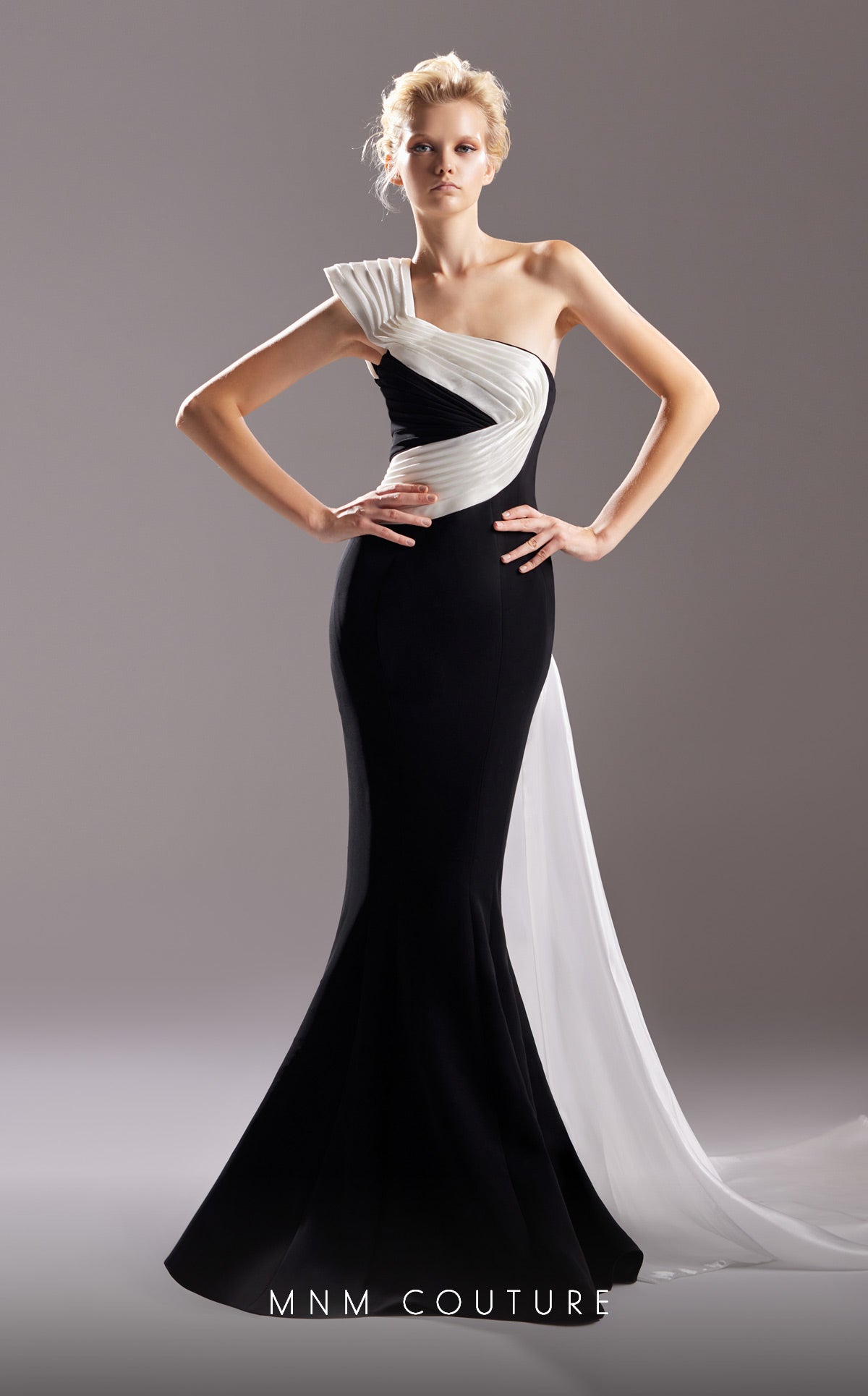 MNM Couture G1502 long one shoulder mermaid style evening gown with perfectly draped fabric details from the shoulder down to the floor.