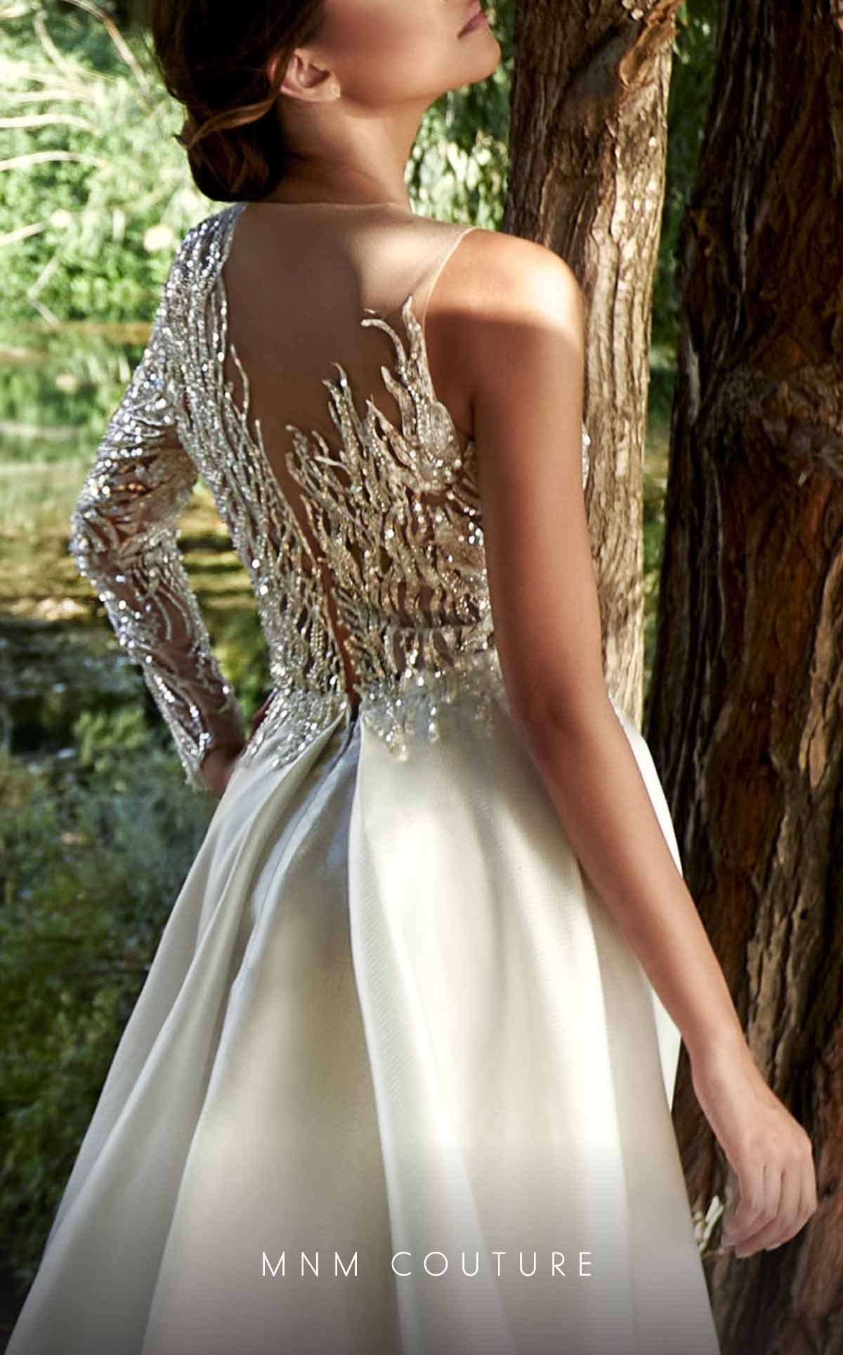 This MNM Couture style is insanely stunning. The flattering beading pattern, one sleeve design and overskirt is sure to compliment your shape in all the right ways