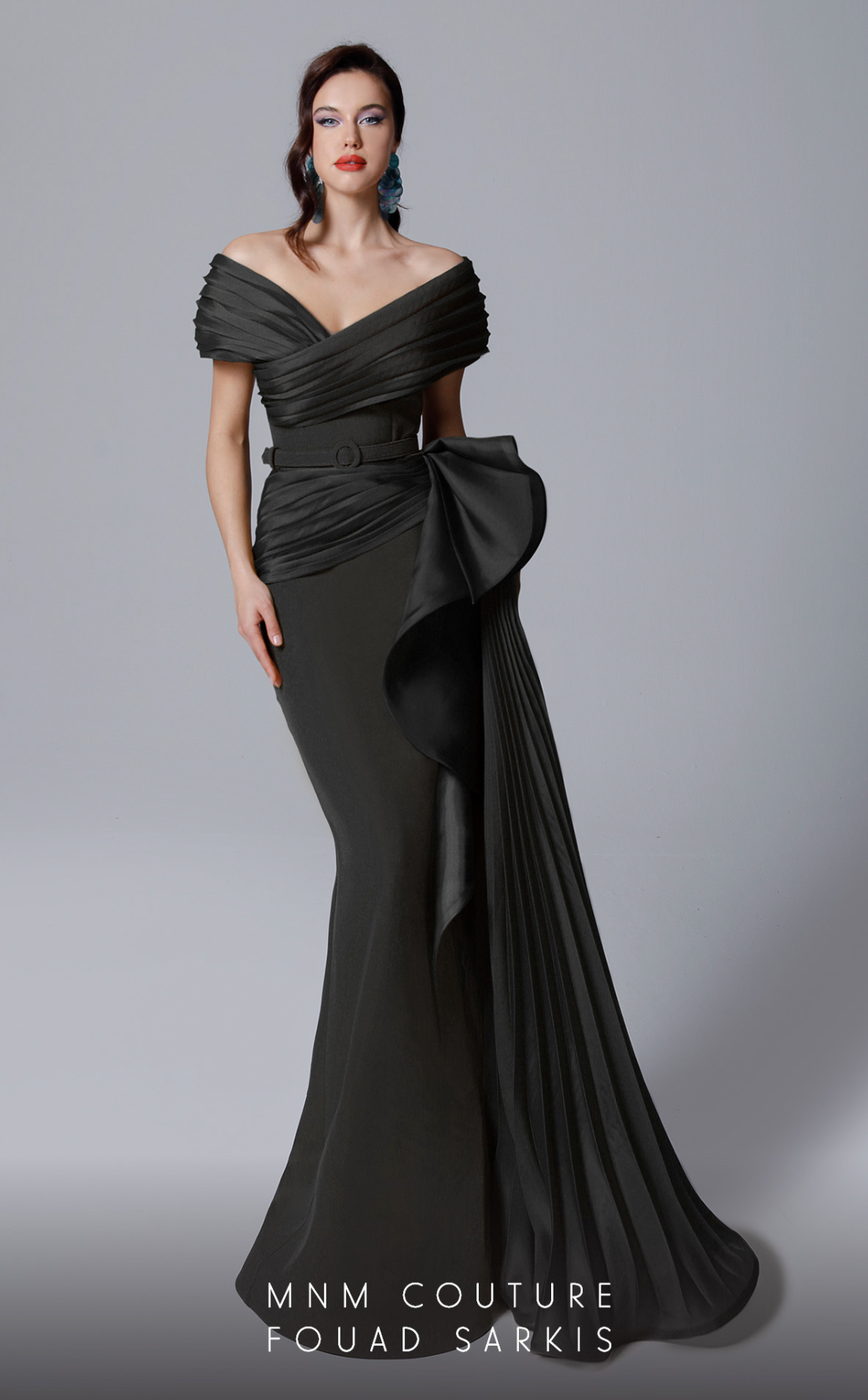 MNM Couture 2692 is the definition of elegance. This beautiful pleated off the shoulder gown with side train hugs curves and compliments all figures.