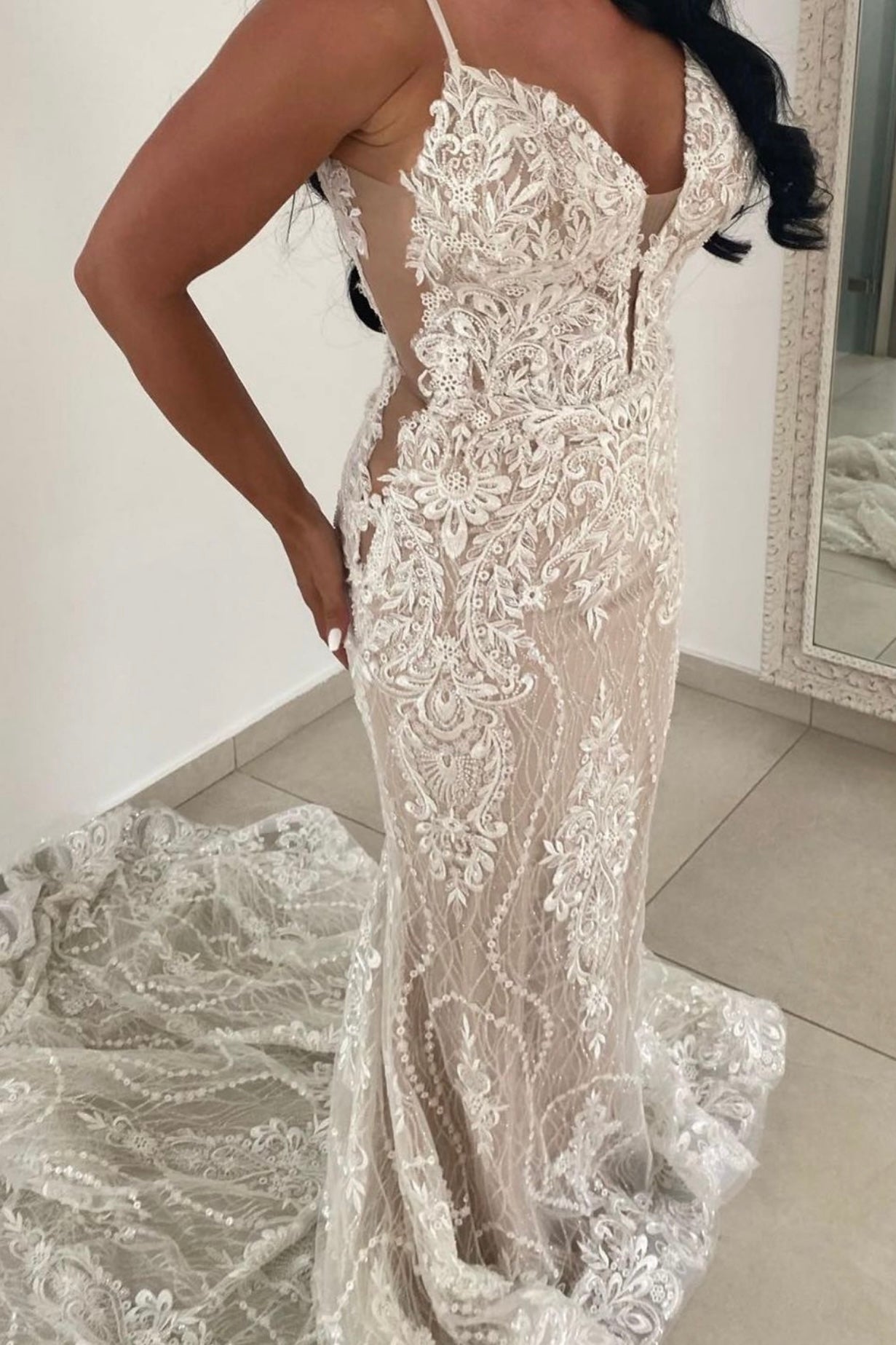 The intricate lace design and fit of this dress is unmatched. The low sheer sides and deep V lace neckline add the perfect touch of elegance. The Clenet Gown by Rene Atelier