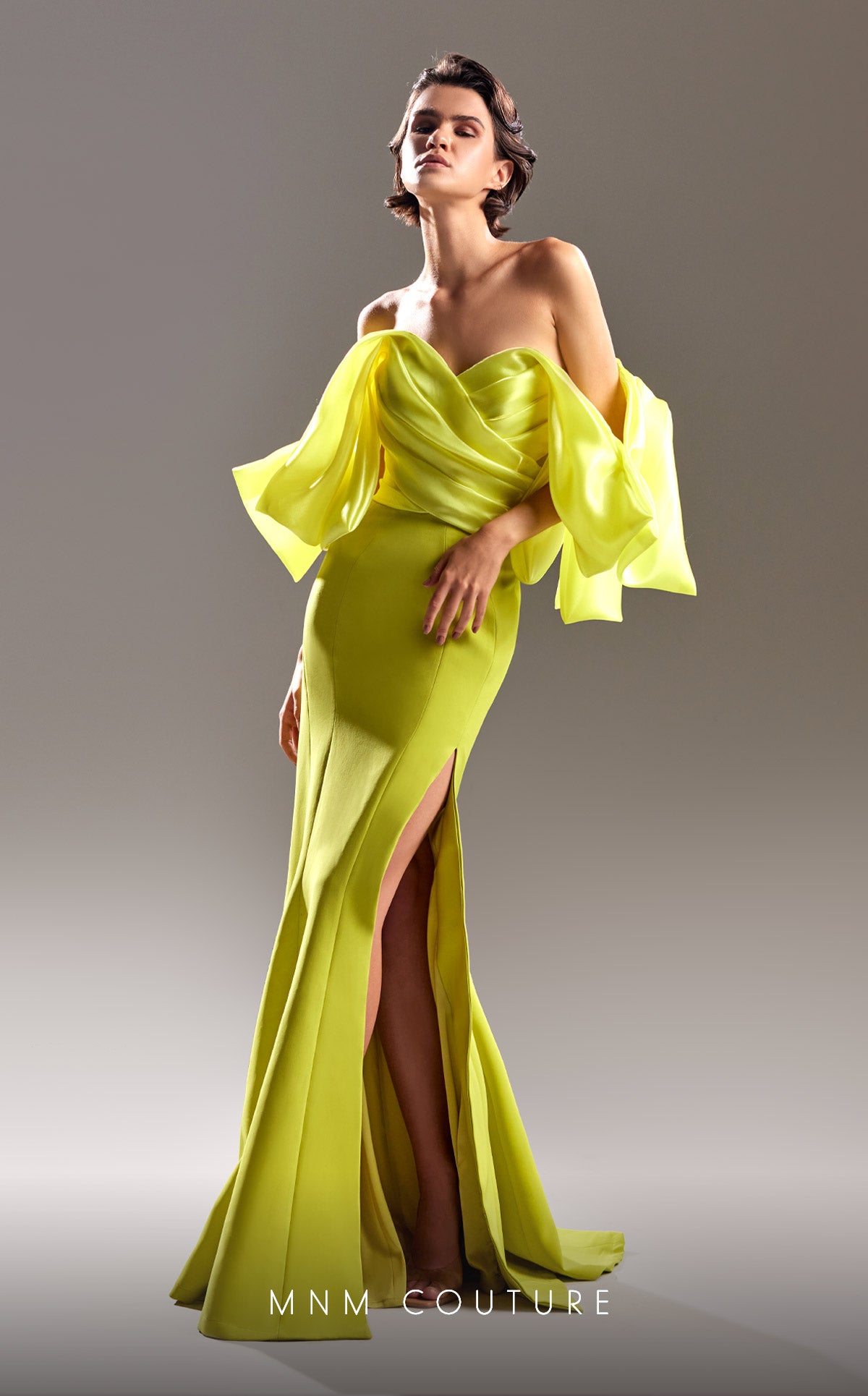 MNM Couture G1508 is a stunning mermaid style with beautiful draped off the shoulder fabric and a high side slit