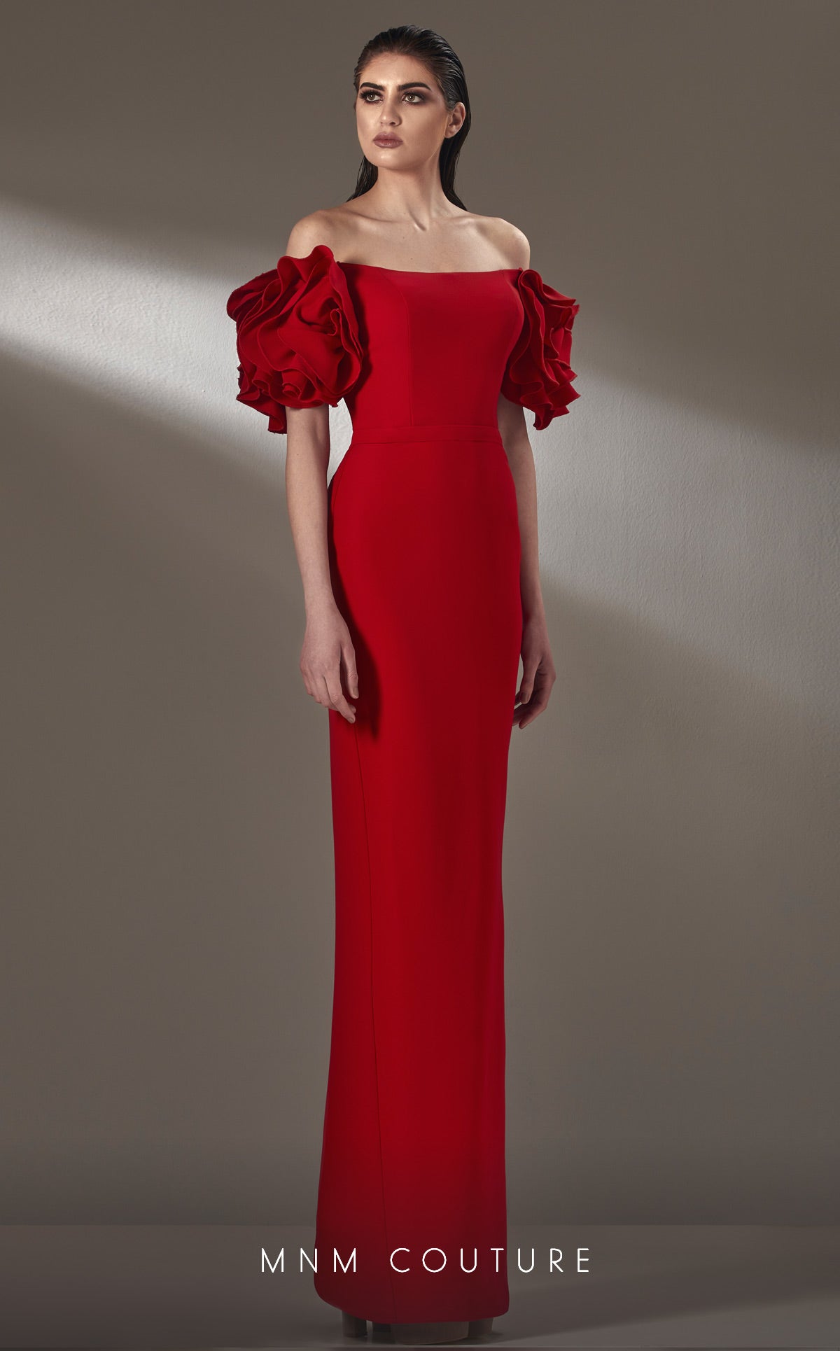 MNM Couture simple and sophisticated beauty. This off the shoulder style with back slit and gorgeous sleeve detail.