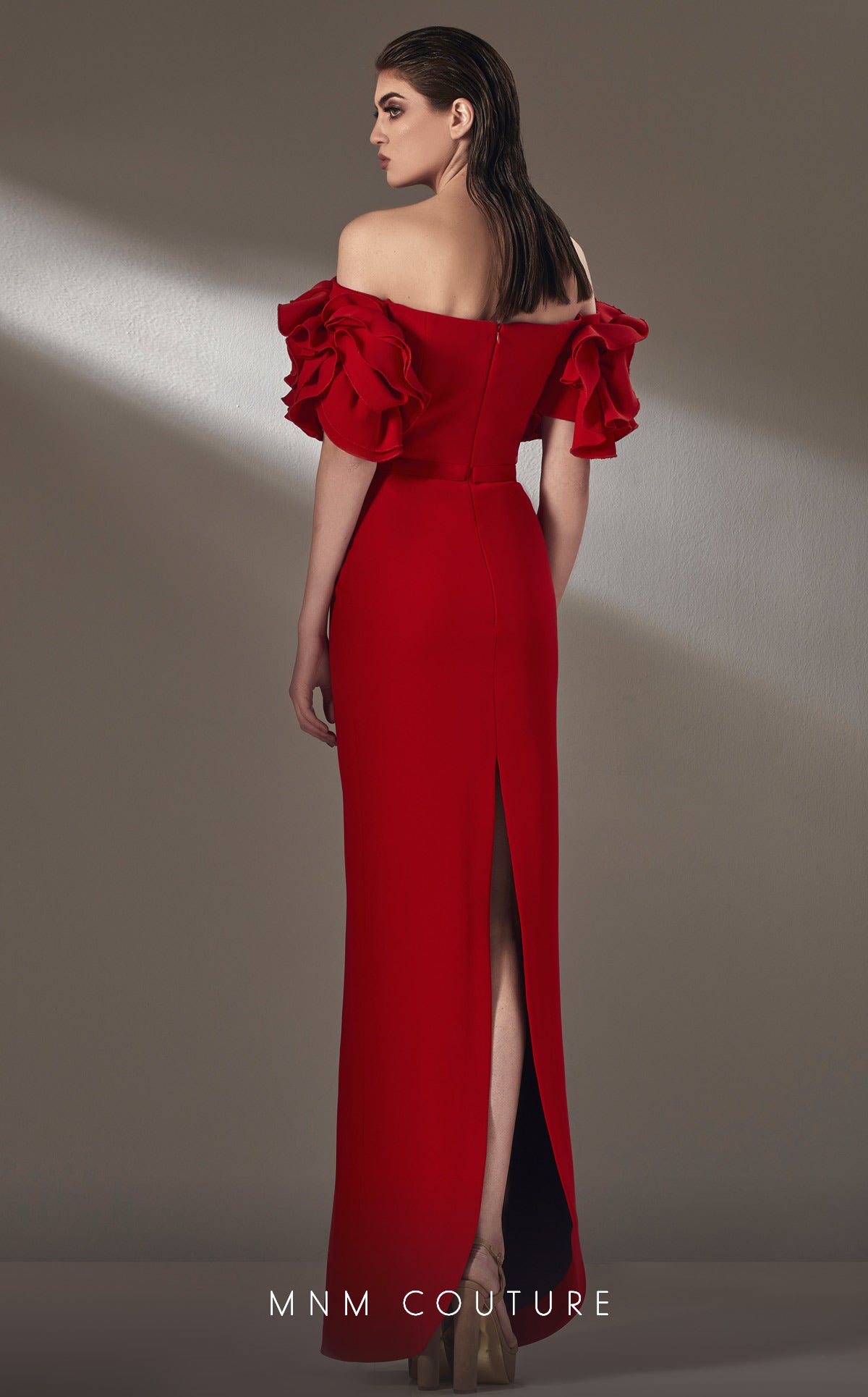 MNM Couture simple and sophisticated beauty. This off the shoulder style with back slit and gorgeous sleeve detail.