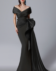 MNM Couture 2692 is the definition of elegance. This beautiful pleated off the shoulder gown with side train hugs curves and compliments all figures.